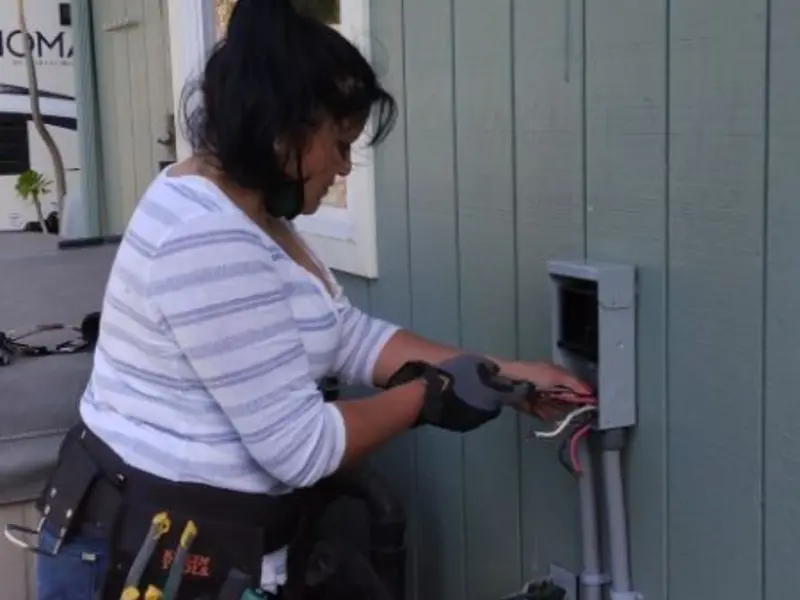 Licensed electrician wiring an exterior subpanel in Elyria